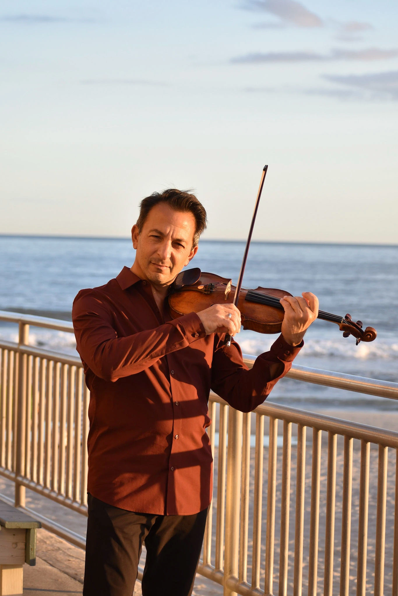 Richard Amoroso playing violin by the ocean